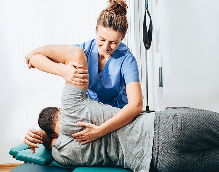 doctor holding patient's hand, shoulder joint treatment